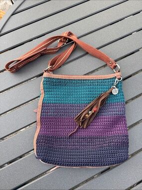 The Sak Crocheted Ombre Crossbody in Teal, Purple & Navy with Brown Trim